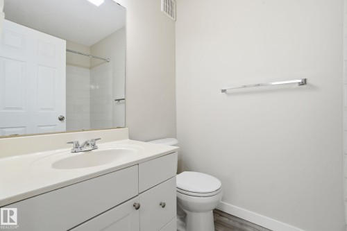 Full bath featuring vanity, wood finished floors, and a shower - 8006 15A Avenue, Edmonton, AB - Indoor Photo Showing Bathroom