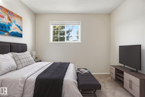 Bedroom with light carpet and baseboards - 8006 15A Avenue, Edmonton, AB - Indoor Photo Showing Bedroom