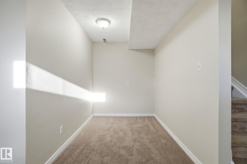 Unfurnished room with a textured ceiling and carpet flooring - 8006 15A Avenue, Edmonton, AB - Indoor Photo Showing Other Room