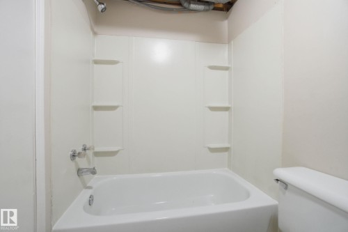 Bathroom with bathtub / shower combination - 8006 15A Avenue, Edmonton, AB - Indoor Photo Showing Bathroom