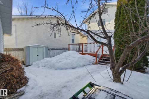 View of snowy exterior with a shed and a wooden deck - 8006 15A Avenue, Edmonton, AB - Outdoor