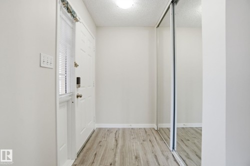Interior space with a textured ceiling and light wood-type flooring - 8006 15A Avenue, Edmonton, AB - Indoor Photo Showing Other Room