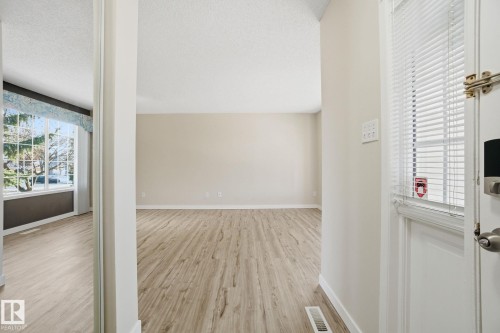 Additional living space with light wood finished floors and baseboards - 8006 15A Avenue, Edmonton, AB - Indoor Photo Showing Other Room