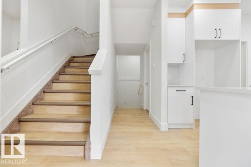 Staircase featuring wood finished floors - 235 Linden Loop, Leduc, AB - Indoor Photo Showing Other Room