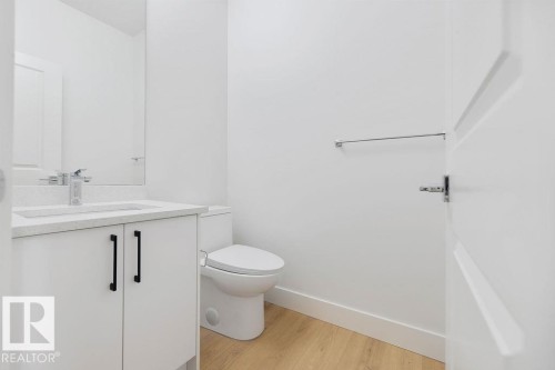 Half bathroom with light wood finished floors and vanity - 235 Linden Loop, Leduc, AB - Indoor Photo Showing Bathroom
