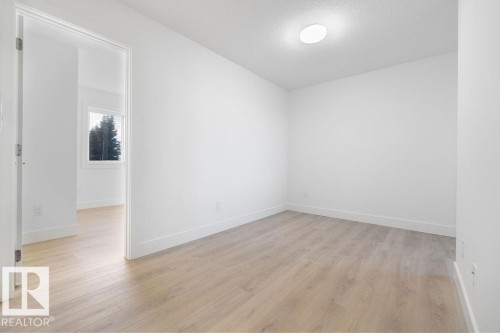Empty room with light wood-type flooring and a textured ceiling - 235 Linden Loop, Leduc, AB - Indoor Photo Showing Other Room