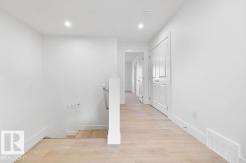 Corridor with an upstairs landing, light wood finished floors, and recessed lighting - 235 Linden Loop, Leduc, AB - Indoor Photo Showing Other Room