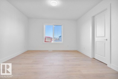 Empty room featuring light wood-type flooring and a textured ceiling - 235 Linden Loop, Leduc, AB - Indoor Photo Showing Other Room