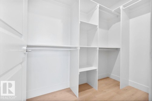 Walk in closet featuring light wood finished floors - 235 Linden Loop, Leduc, AB - Indoor With Storage