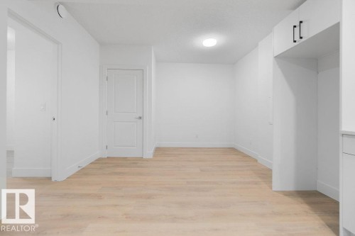 Basement with light wood-type flooring and a textured ceiling - 235 Linden Loop, Leduc, AB - Indoor Photo Showing Other Room
