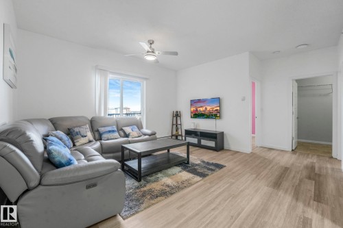 Living room featuring light wood-style floors and ceiling fan - 419 396 Silverberry Road, Edmonton, AB - Indoor Photo Showing Living Room