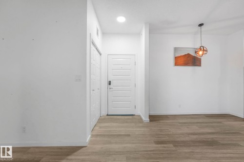 Hallway with light wood-style flooring and recessed lighting - 419 396 Silverberry Road, Edmonton, AB - Indoor Photo Showing Other Room