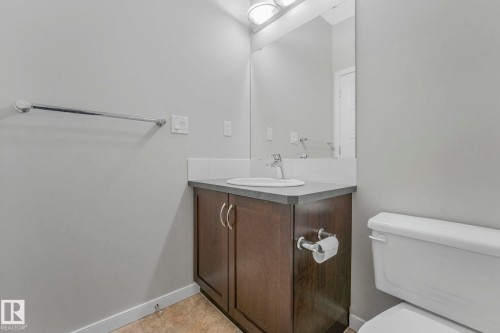Half bathroom featuring vanity and light tile patterned flooring - 419 396 Silverberry Road, Edmonton, AB - Indoor Photo Showing Bathroom
