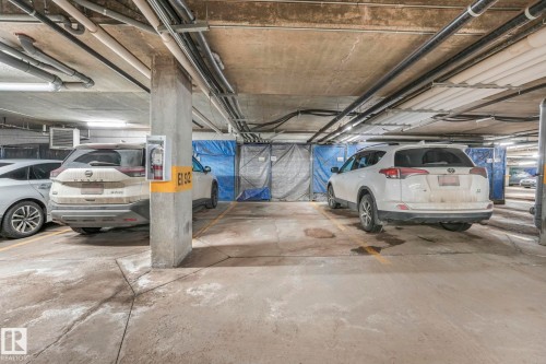 Heated underground parking with storage stall E192 - 419 396 Silverberry Road, Edmonton, AB - Indoor Photo Showing Garage
