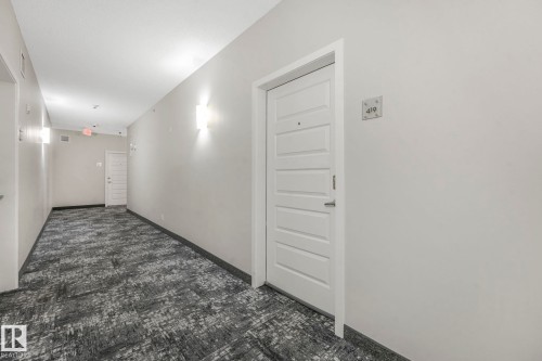 Corridor with baseboards - 419 396 Silverberry Road, Edmonton, AB - Indoor Photo Showing Other Room