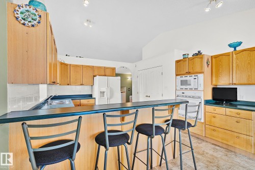 Kitchen with breakfast bar. - 2 Creekside Way, Spruce Grove, AB - Indoor Photo Showing Kitchen