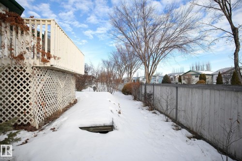 Yard covered in snow featuring a residential view - 2 Creekside Way, Spruce Grove, AB - Outdoor