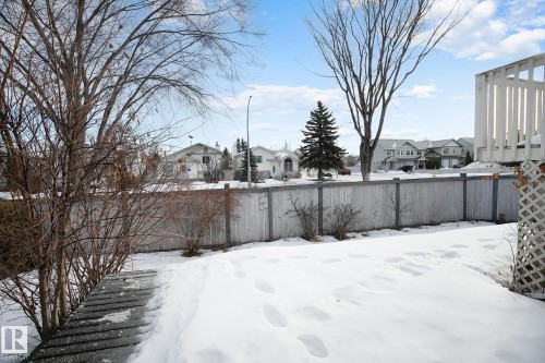 Yard layered in snow with a residential view - 2 Creekside Way, Spruce Grove, AB - Outdoor