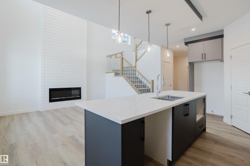 134 Mitchell Bend, Leduc, AB - Indoor Photo Showing Kitchen With Fireplace With Double Sink