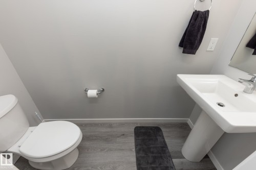 Bathroom featuring light wood-type flooring and toilet - 56 320 Secord Boulevard, Edmonton, AB - Indoor Photo Showing Bathroom