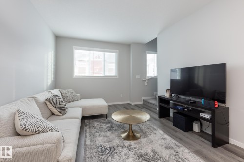 Living area with light wood-style floors and stairs - 56 320 Secord Boulevard, Edmonton, AB - Indoor Photo Showing Living Room