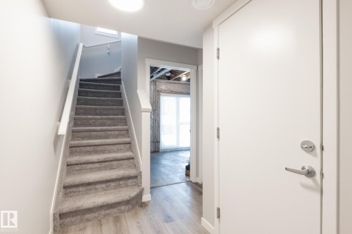 Stairway with wood finished floors and baseboards - 56 320 Secord Boulevard, Edmonton, AB - Indoor Photo Showing Other Room