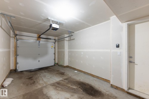 Garage with a garage door opener - 56 320 Secord Boulevard, Edmonton, AB - Indoor Photo Showing Garage