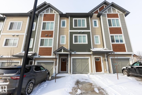 Craftsman-style house featuring an attached garage and a residential view - 56 320 Secord Boulevard, Edmonton, AB - Outdoor With Facade