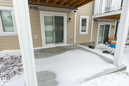 Snow covered patio featuring a patio - 56 320 Secord Boulevard, Edmonton, AB - Outdoor With Exterior