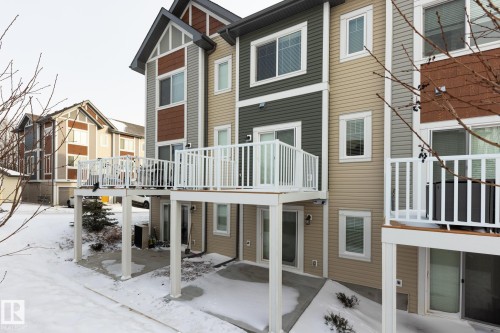 Back of property with a patio and a residential view - 56 320 Secord Boulevard, Edmonton, AB - Outdoor