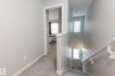 Staircase with carpet flooring and baseboards - 56 320 Secord Boulevard, Edmonton, AB  - Indoor Photo Showing Other Room 