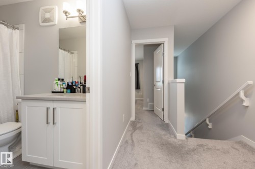 Corridor featuring an upstairs landing and light colored carpet - 56 320 Secord Boulevard, Edmonton, AB - Indoor Photo Showing Bathroom