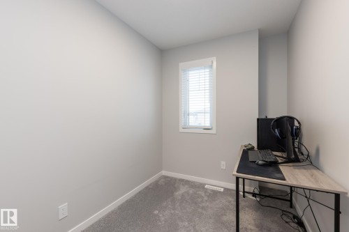 Home office with carpet floors and baseboards - 56 320 Secord Boulevard, Edmonton, AB - Indoor Photo Showing Office