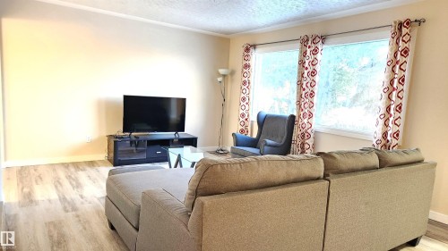 Living area featuring light wood-style floors and a textured ceiling - 4709 106 Street, Edmonton, AB - Indoor Photo Showing Living Room