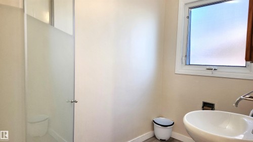 Bathroom with a sink and toilet - 4709 106 Street, Edmonton, AB - Indoor Photo Showing Bathroom