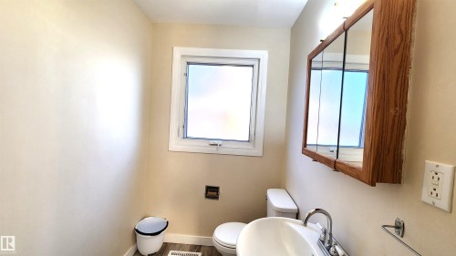 Bathroom with toilet and wood finished floors - 4709 106 Street, Edmonton, AB - Indoor Photo Showing Bathroom