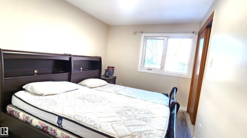 Bedroom with baseboards and wood finished floors - 4709 106 Street, Edmonton, AB - Indoor Photo Showing Bedroom
