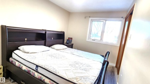 Bedroom with wood finished floors and baseboards - 4709 106 Street, Edmonton, AB - Indoor Photo Showing Bedroom