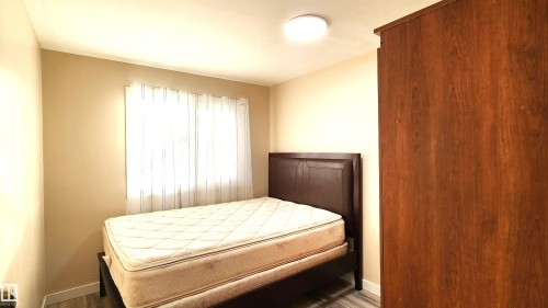 Bedroom featuring baseboards and wood finished floors - 4709 106 Street, Edmonton, AB - Indoor Photo Showing Bedroom