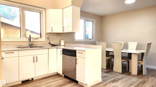 Kitchen featuring light countertops, stainless steel dishwasher, light wood-style flooring, and recessed lighting - 4709 106 Street, Edmonton, AB - Indoor Photo Showing Kitchen With Double Sink