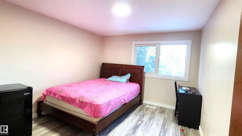 Bedroom featuring light wood-style floors and baseboards - 4709 106 Street, Edmonton, AB - Indoor Photo Showing Bedroom