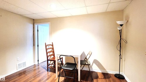 Dining space featuring a drop ceiling and wood finished floors - 4709 106 Street, Edmonton, AB - Indoor