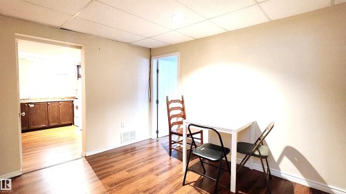 Dining space featuring a paneled ceiling and light wood finished floors - 4709 106 Street, Edmonton, AB - Indoor