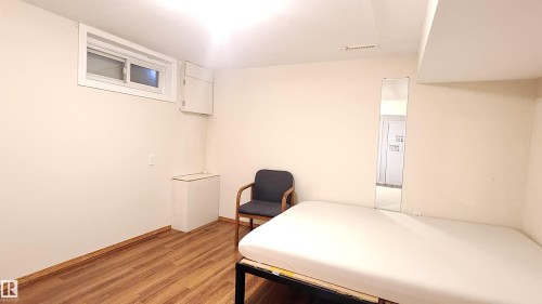 Bedroom featuring light wood finished floors and baseboards - 4709 106 Street, Edmonton, AB - Indoor
