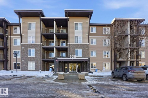 Snow covered building featuring a view of apartment building / complex - 318 530 Watt Boulevard, Edmonton, AB - Outdoor With Facade