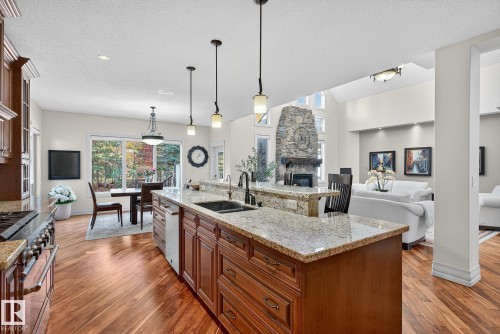 54 53305 Rge Road 273, Rural Parkland County, AB - Indoor Photo Showing Kitchen With Fireplace With Double Sink With Upgraded Kitchen