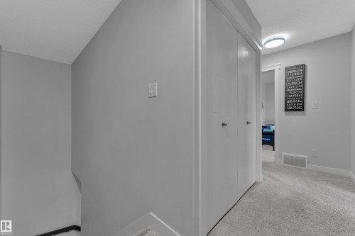 Corridor featuring light carpet and baseboards - 906 Berg Place, Leduc, AB - Indoor Photo Showing Other Room