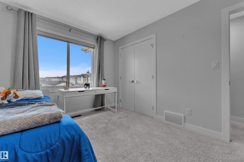 Carpeted bedroom with baseboards and a closet - 906 Berg Place, Leduc, AB - Indoor Photo Showing Bedroom