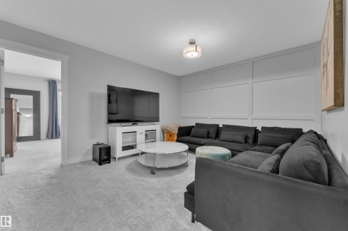 Living area featuring light carpet - 906 Berg Place, Leduc, AB - Indoor Photo Showing Other Room