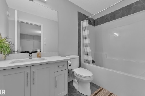 Full bathroom featuring shower / bath combination with curtain and vanity - 906 Berg Place, Leduc, AB - Indoor Photo Showing Bathroom